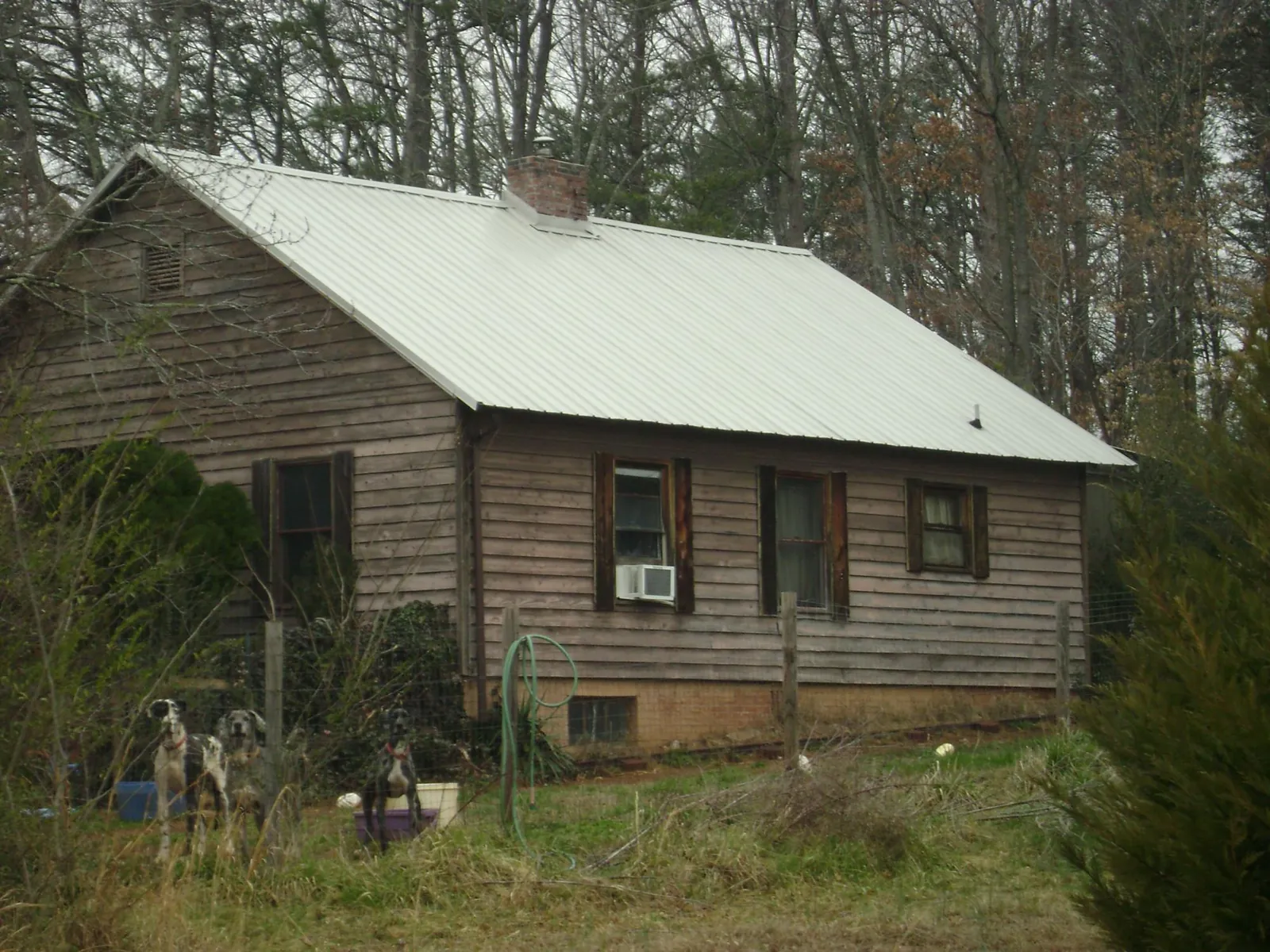 White metal roof on an old wood sided farmhouse, from a Metal Roof Installation job in Darien